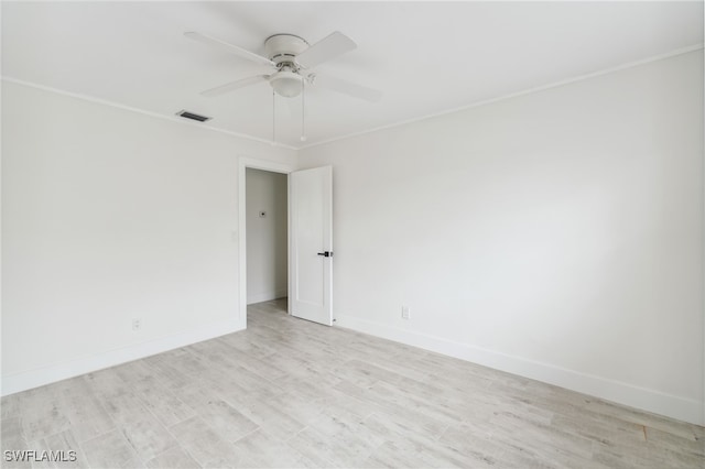 empty room with ornamental molding, light wood-type flooring, and ceiling fan