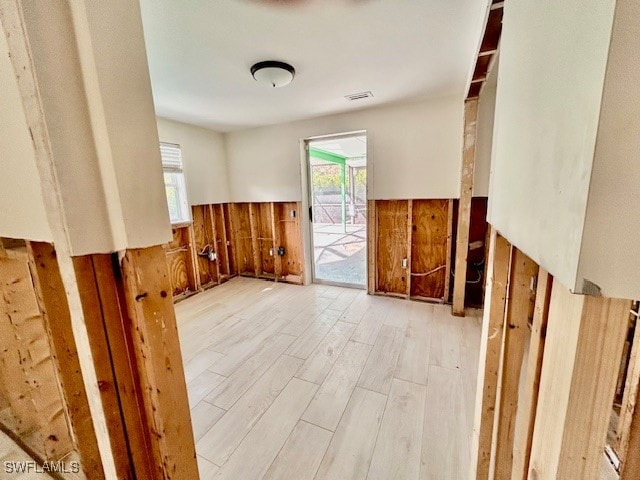 empty room featuring light hardwood / wood-style flooring and wooden walls