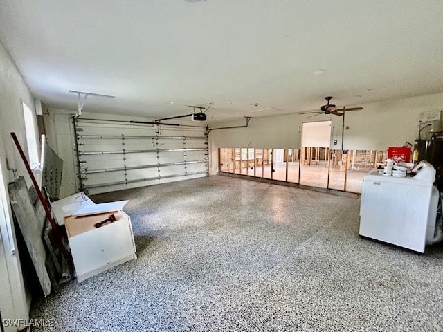 garage with a garage door opener, ceiling fan, and washer / dryer