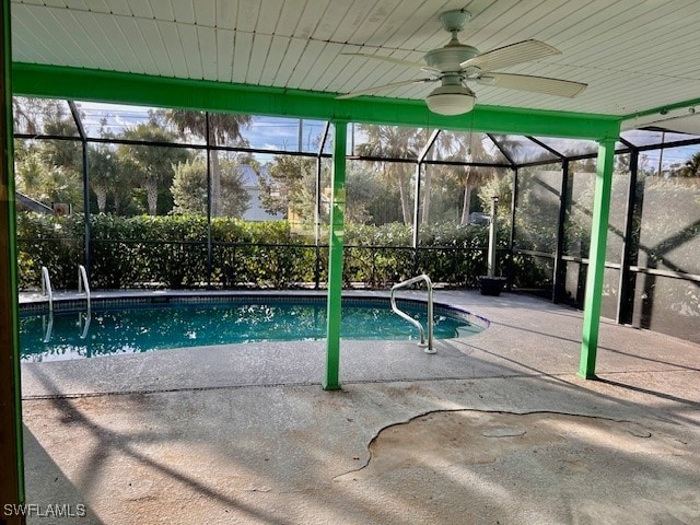 view of swimming pool featuring a patio area, a lanai, and ceiling fan