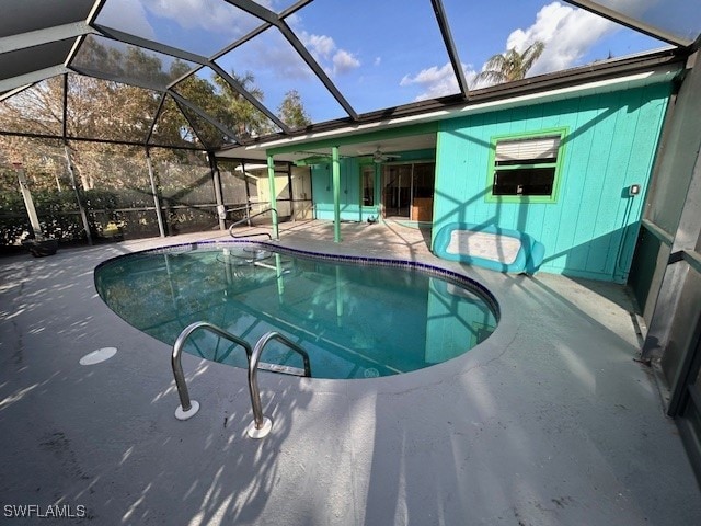 view of swimming pool featuring a patio, a lanai, and ceiling fan