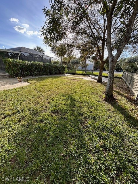 view of yard featuring glass enclosure