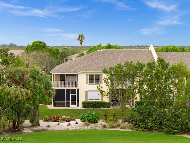 back of house featuring a sunroom and a yard