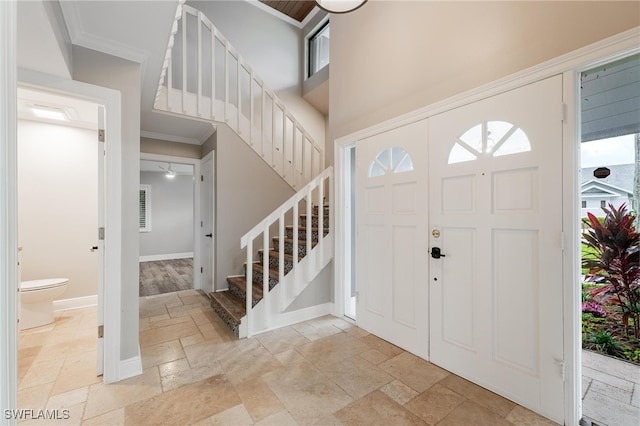 foyer featuring crown molding