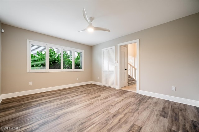 empty room featuring ceiling fan and light hardwood / wood-style floors