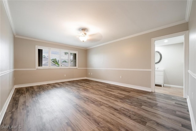 empty room featuring ceiling fan, wood-type flooring, and ornamental molding