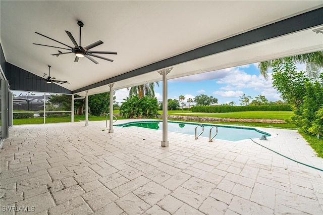 view of pool featuring ceiling fan, a yard, a patio, and a lanai