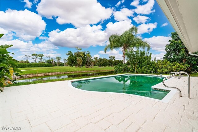 view of swimming pool featuring a water view and a patio