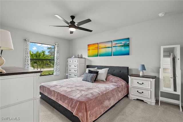 bedroom featuring light colored carpet and ceiling fan