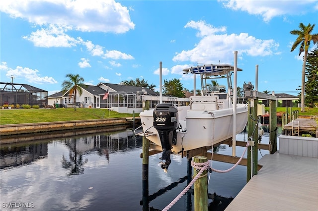 dock area featuring glass enclosure, a water view, and a yard