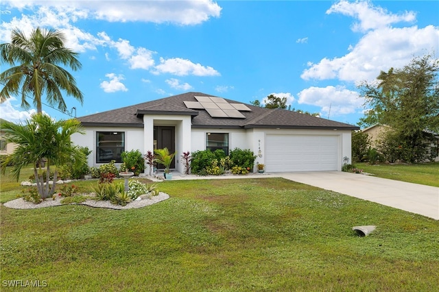 view of front of house with solar panels, a front lawn, and a garage