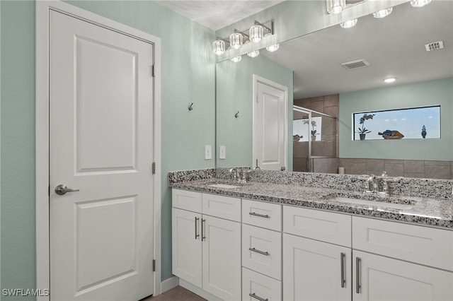 bathroom with vanity and an enclosed shower