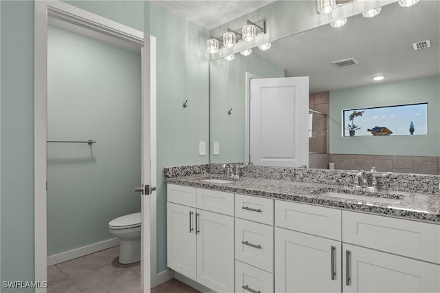 bathroom featuring vanity, walk in shower, tile patterned flooring, and toilet