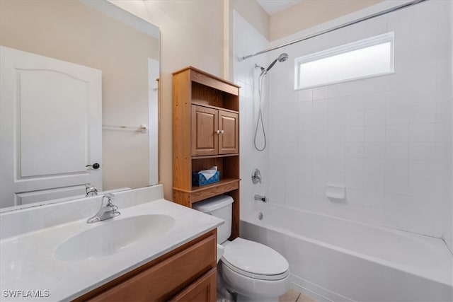 full bathroom featuring vanity, toilet, and tiled shower / bath