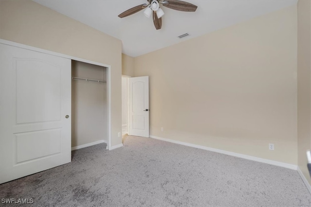 unfurnished bedroom with carpet, ceiling fan, and a closet