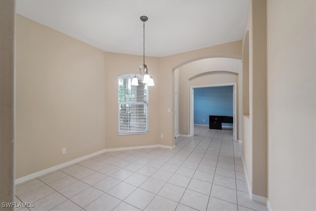 unfurnished dining area with a notable chandelier and light tile patterned floors