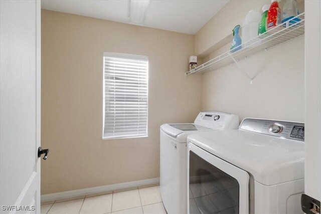 2798 Via Piazza Loop, Fort Myers, FL 33905 - laundry area featuring separate washer and dryer, baseboards, and light tile patterned floors