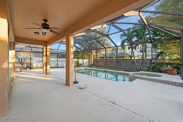 view of pool with a lanai, ceiling fan, an in ground hot tub, and a patio area