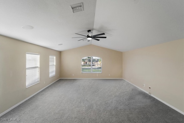 unfurnished room with lofted ceiling, carpet flooring, and ceiling fan