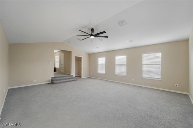 unfurnished living room featuring light colored carpet, ceiling fan, and vaulted ceiling