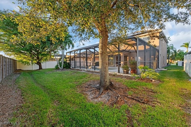 view of yard with glass enclosure and a pool