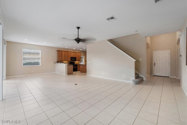 unfurnished living room with ceiling fan and light tile patterned flooring