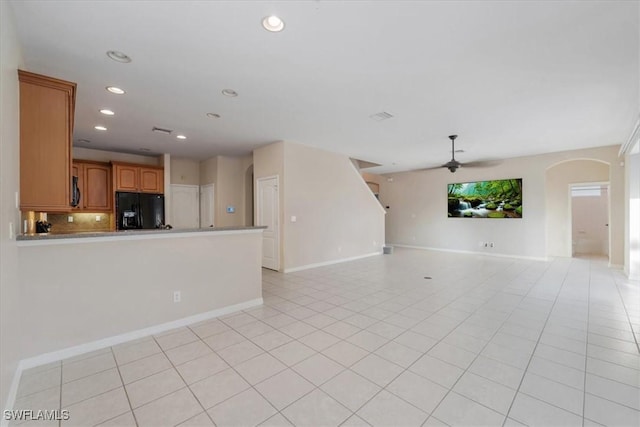 2798 Via Piazza Loop, Fort Myers, FL 33905 - unfurnished living room with a ceiling fan, arched walkways, baseboards, light tile patterned floors, and recessed lighting