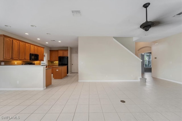 kitchen featuring decorative backsplash, black appliances, light tile patterned flooring, and ceiling fan