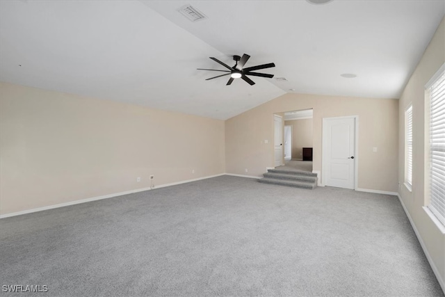 unfurnished living room featuring lofted ceiling, carpet, and ceiling fan