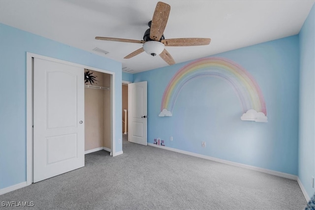 unfurnished bedroom featuring ceiling fan, carpet flooring, and a closet