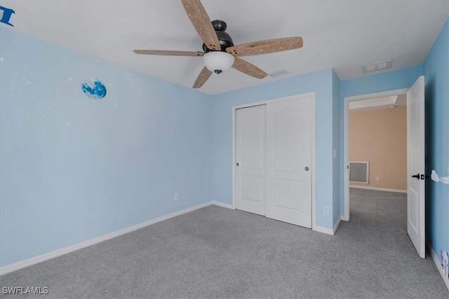 unfurnished bedroom featuring ceiling fan, light carpet, and a closet