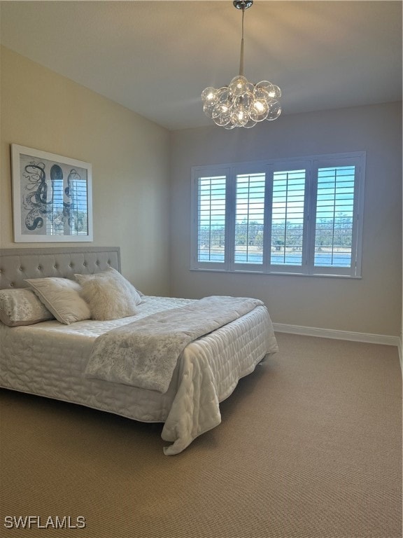 bedroom featuring multiple windows, carpet, and a notable chandelier