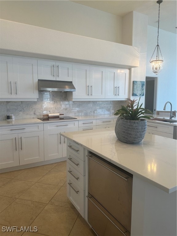 kitchen featuring hanging light fixtures, light tile patterned floors, black electric cooktop, tasteful backsplash, and white cabinetry