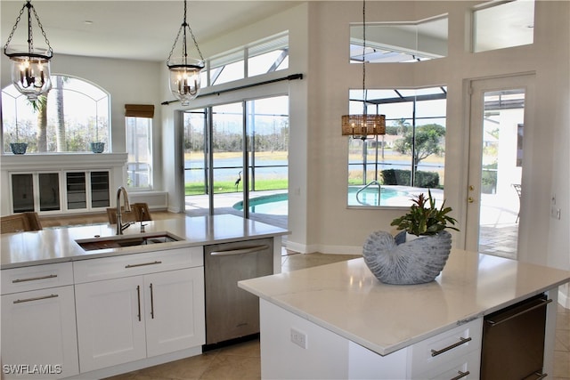 kitchen featuring white cabinetry, a kitchen island with sink, and plenty of natural light