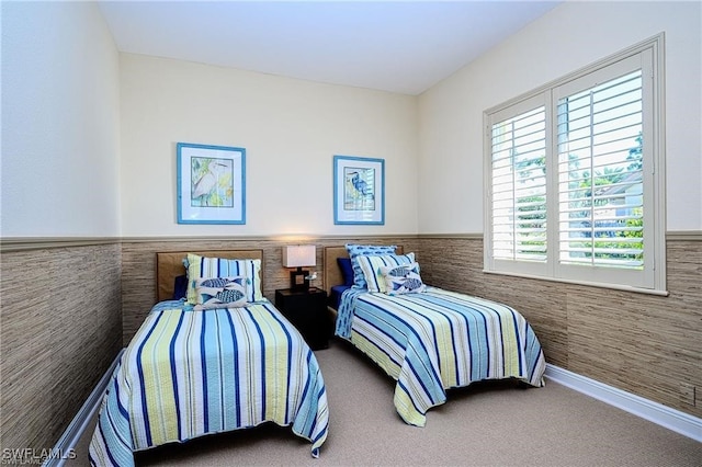 bedroom featuring carpet floors and tile walls