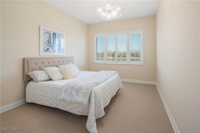 carpeted bedroom with a notable chandelier and baseboards