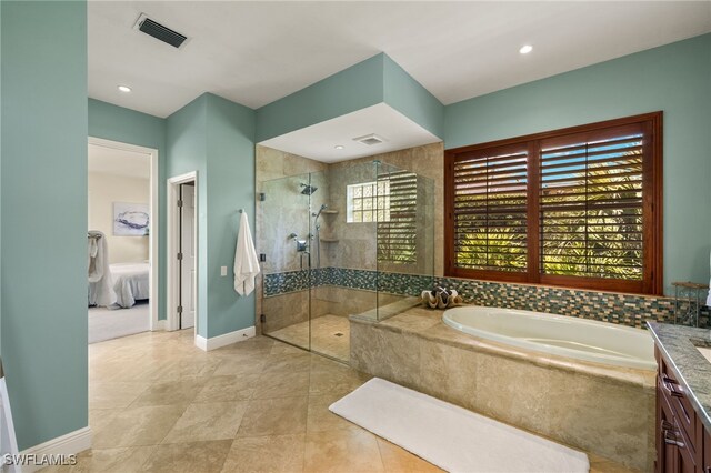 bathroom with a bath, visible vents, tiled shower, and ensuite bathroom