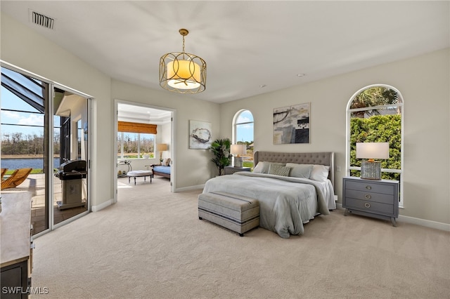 carpeted bedroom with access to outside, visible vents, and baseboards