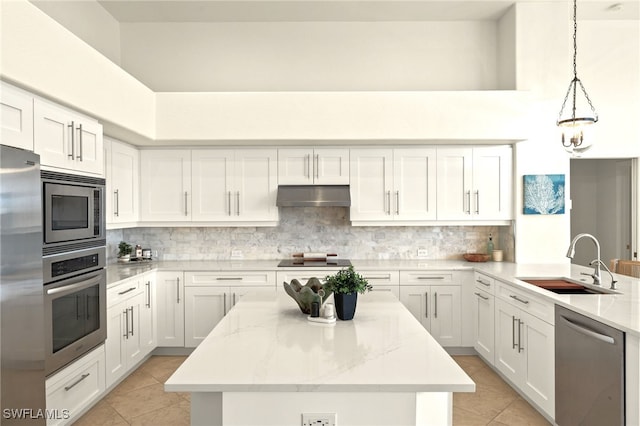 kitchen with light tile patterned floors, appliances with stainless steel finishes, a sink, and under cabinet range hood