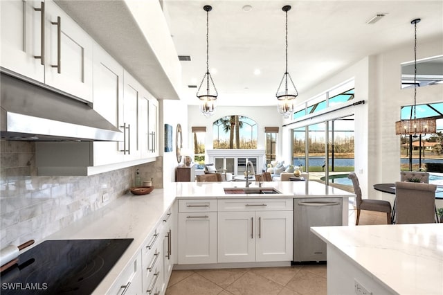 kitchen featuring visible vents, a sink, black electric stovetop, under cabinet range hood, and stainless steel dishwasher