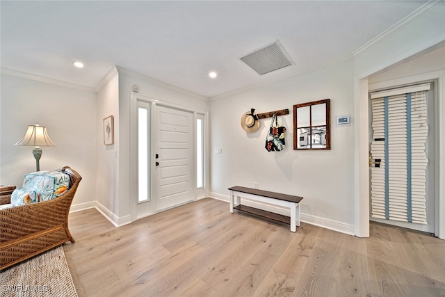 entrance foyer featuring light hardwood / wood-style floors and crown molding