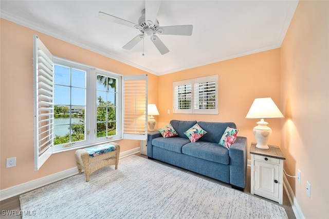 living room featuring ornamental molding, ceiling fan, wood-type flooring, and a healthy amount of sunlight