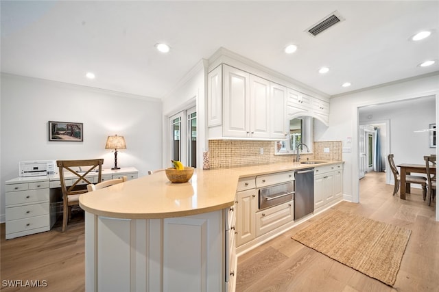 kitchen featuring light hardwood / wood-style floors, dishwasher, kitchen peninsula, a wealth of natural light, and white cabinetry