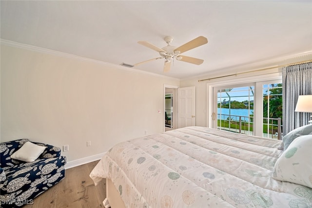 bedroom with access to outside, a water view, hardwood / wood-style floors, ornamental molding, and ceiling fan