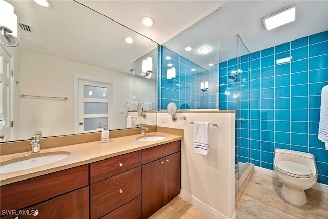 bathroom with tile walls, vanity, tile patterned floors, and a shower