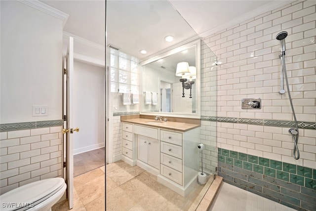 bathroom with tiled shower, tile patterned floors, tile walls, vanity, and crown molding