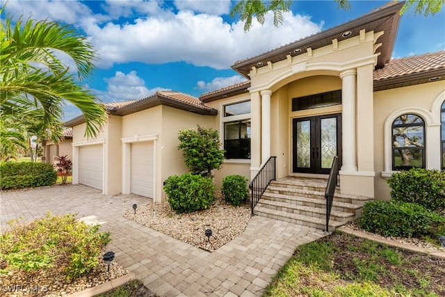 view of exterior entry with a garage