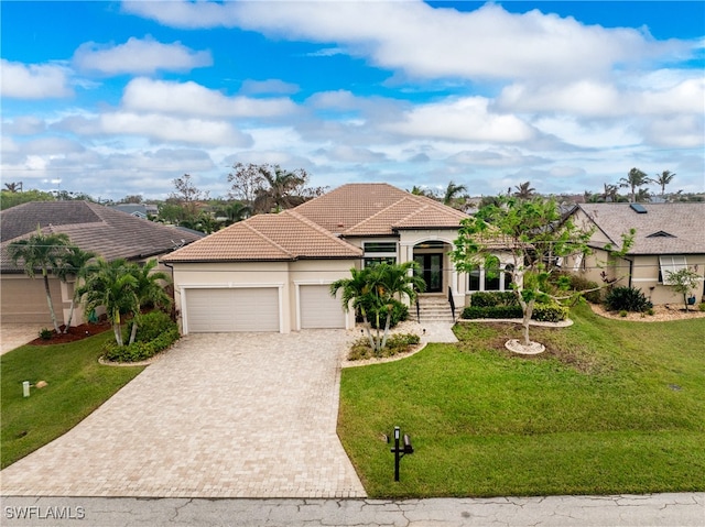 mediterranean / spanish-style house with a garage and a front yard