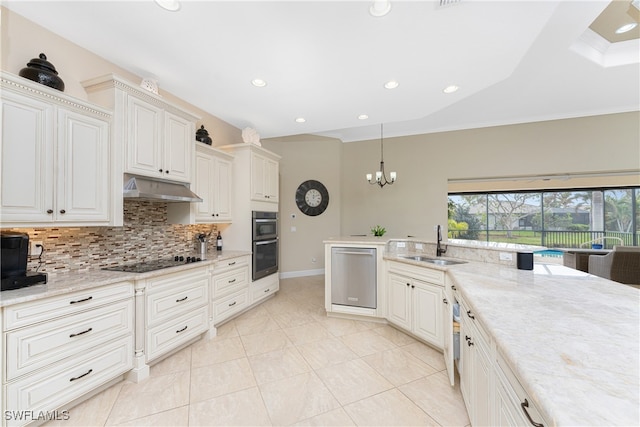 kitchen with stainless steel appliances, a notable chandelier, sink, light stone countertops, and pendant lighting