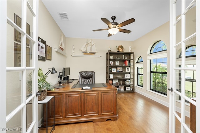 office space with ceiling fan, light wood-type flooring, and french doors